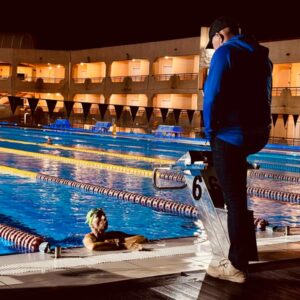 Robin Brew personal coaching a swimmer in the pool at night